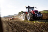 Tractor equipped with Michelin Axiobib 2 tires working in a field with agricultural equipment