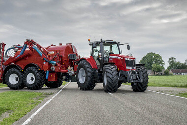 Agricultural tractor and equipment traveling on a paved rural road