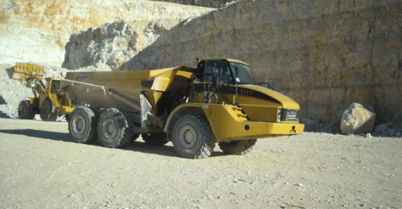 Yellow articulated dump truck in action