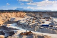 Earthmoving equipment operating across a large quarry