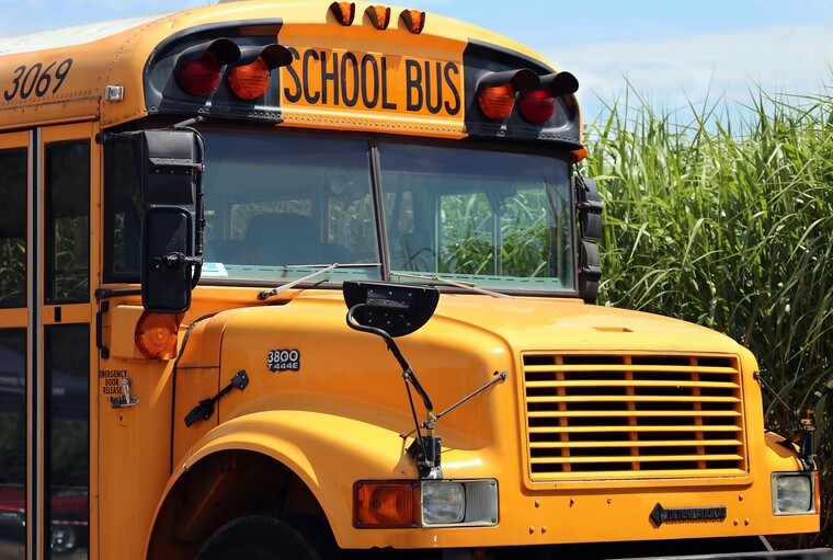 School bus image in front of field