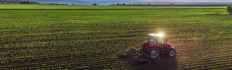 tractor tyres Tractor cultivating field at spring,aerial view