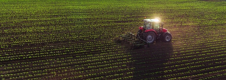 Tractor cultivating field at spring,aerial view