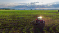 Tractor cultivating field at spring,aerial view