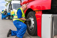Mechanic changing semi-truck tire for OnCall tire care services