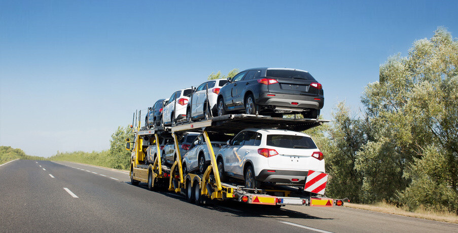 Big car carrier trailer with new cars for sale on bunk platform. Car transport truck on the highway; Shutterstock ID 1024882123