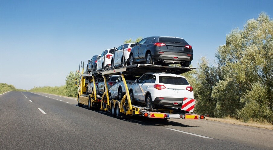 Big car carrier trailer with new cars for sale on bunk platform. Car transport truck on the highway; Shutterstock ID 1024882123