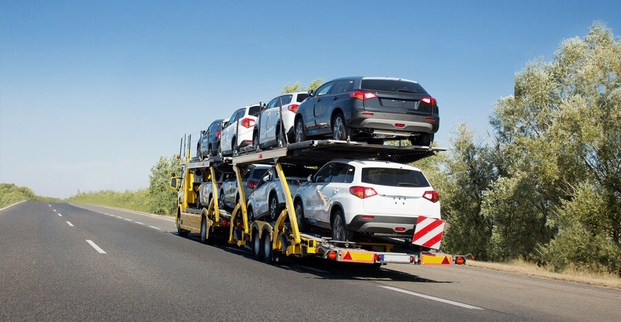 Big car carrier trailer with new cars for sale on bunk platform. Car transport truck on the highway; Shutterstock ID 1024882123