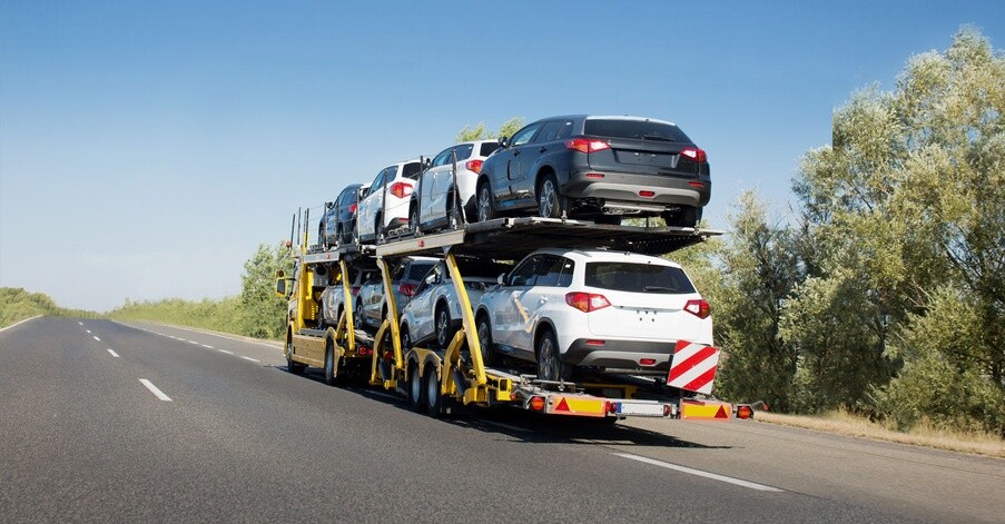 Big car carrier trailer with new cars for sale on bunk platform. Car transport truck on the highway; Shutterstock ID 1024882123