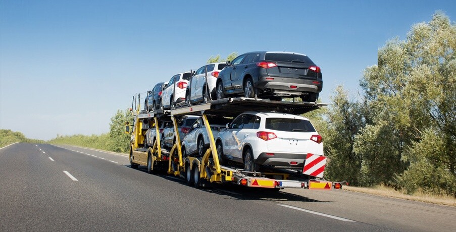 Big car carrier trailer with new cars for sale on bunk platform. Car transport truck on the highway; Shutterstock ID 1024882123