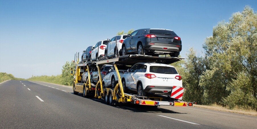 Big car carrier trailer with new cars for sale on bunk platform. Car transport truck on the highway; Shutterstock ID 1024882123