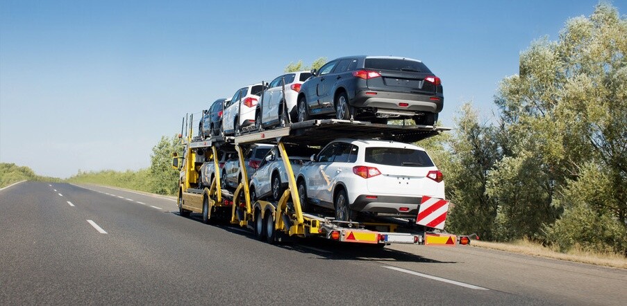 Big car carrier trailer with new cars for sale on bunk platform. Car transport truck on the highway; Shutterstock ID 1024882123