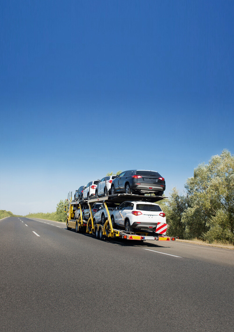 Big car carrier trailer with new cars for sale on bunk platform. Car transport truck on the highway; Shutterstock ID 1024882123
