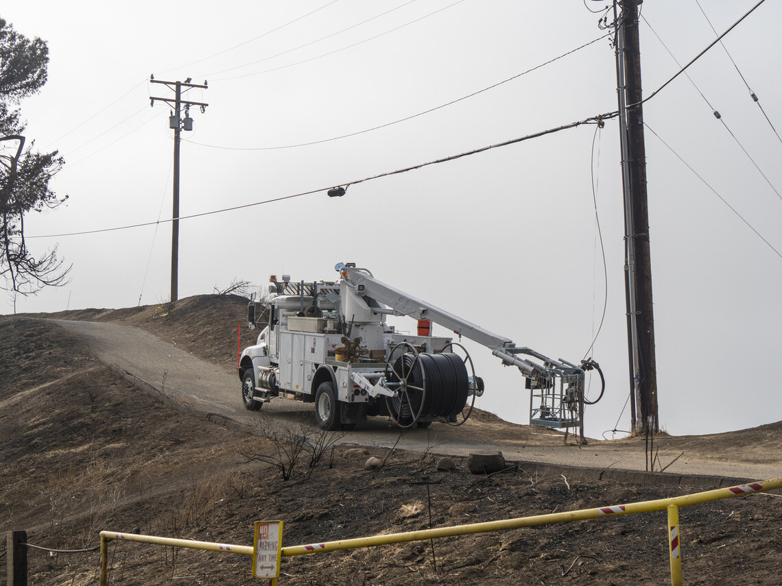 Telecom utility truck going up a hill