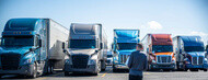 man inspecting semi trucks