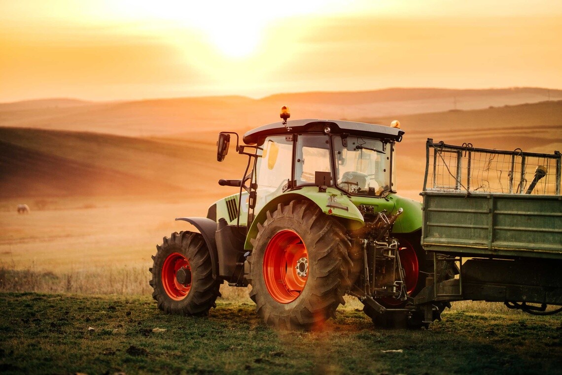 Image of tractor and implement in a field at sunset with Michelin tires