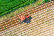 Aerial view of tractor plowing field
