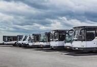 Fleet of commercial buses parked at a service facility
