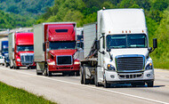 A convoy of semi trucks on the road