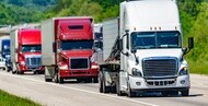 A convoy of semi trucks on the road