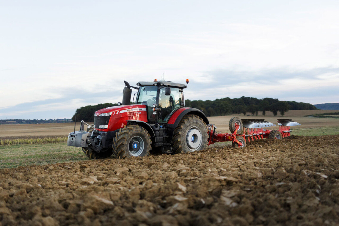 Tractor pulling agricultural equipment through a field