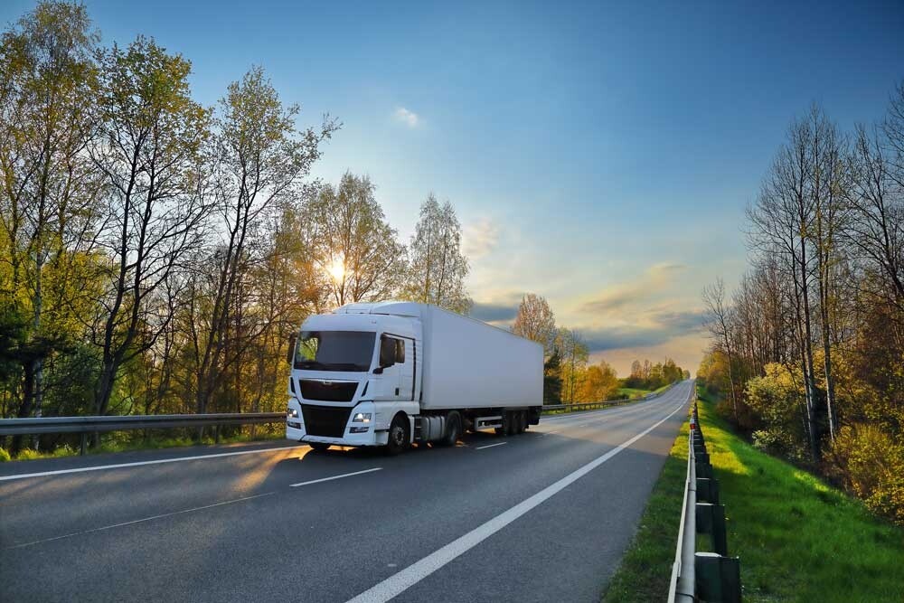 HGV on a tree-lined road