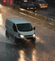 Van rolling on a wet road