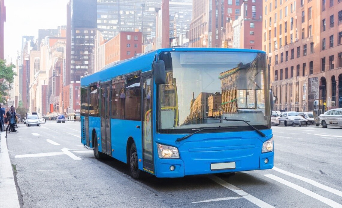 Blue transit bus stopped on city street