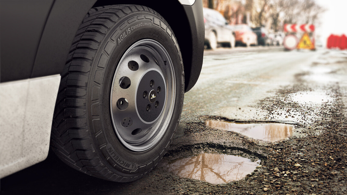 Agilis tire rolling into muddy potholes on street