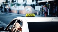 White taxi in service in the city