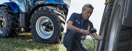 Man adjusting the pressure of his tractor tires