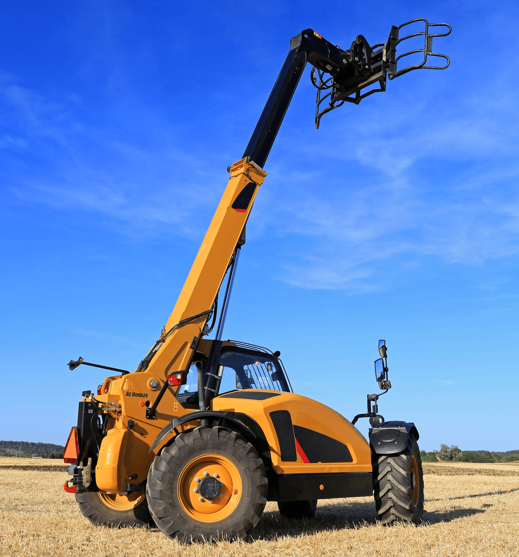 Yellow telescopic forklift with raised boom in an agricultural field.