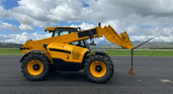 Yellow telehandler with its boom and forks extended