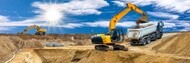 equipment working on construction site against a blue sky