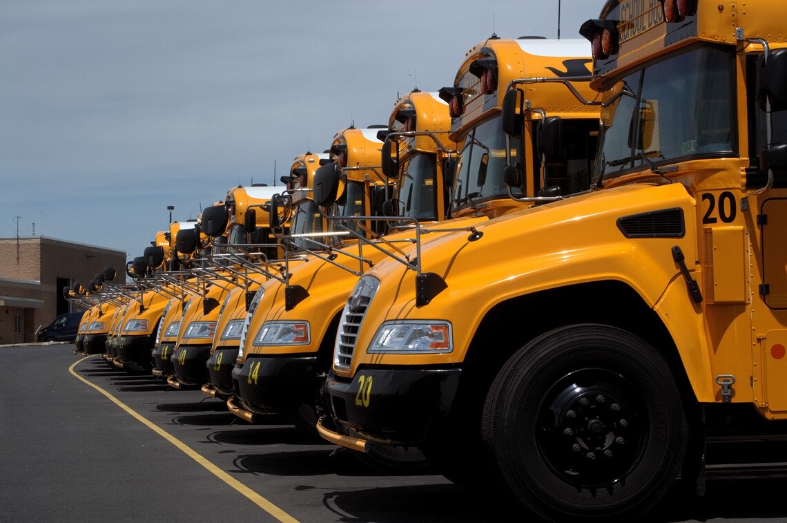 Fleet of yellow school buses parked in a line