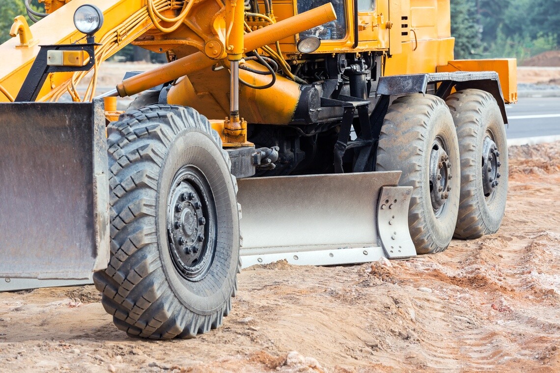 yellow grader on dirt