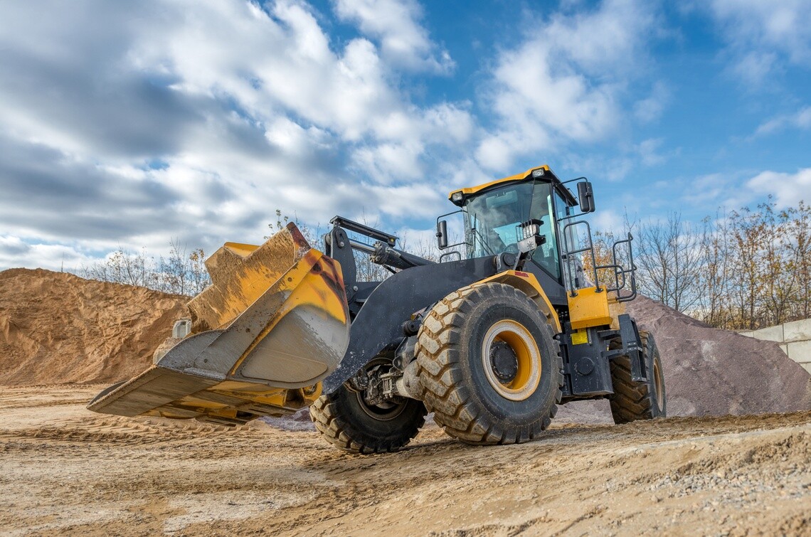 wheel loader moving through dirt at construction site