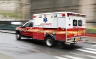 Ambulance with blurred background to depict driving fast