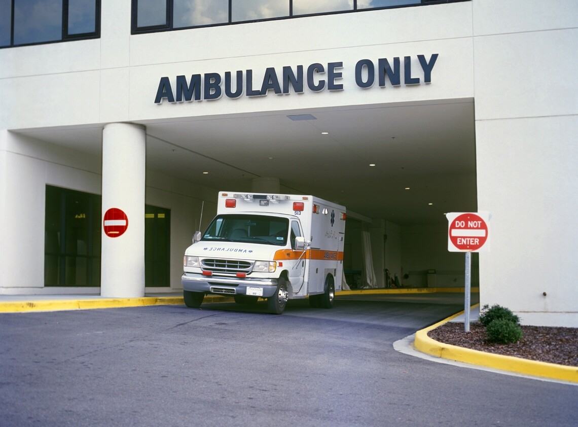 Ambulance parked under ambulance only parking at hospital