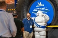Image of Michelin man and minexpo participant in front of mining tire