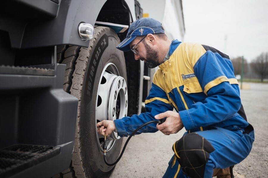 michelin mechanic checking tyre pressure