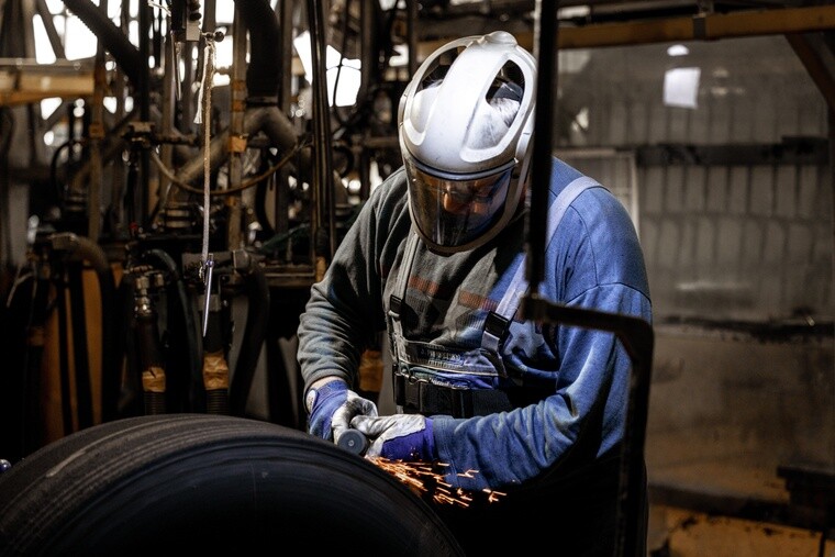 Un technicien réalisant le rechapage d’un pneu