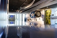 View of a room with two tires on display, one with the rubber, the other with no rubber to show the inner works of the tire.