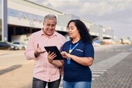 Fleet professionals reviewing vehicle information on a tablet