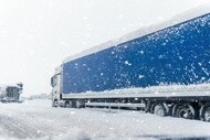 Truck driving on a snow-covered road