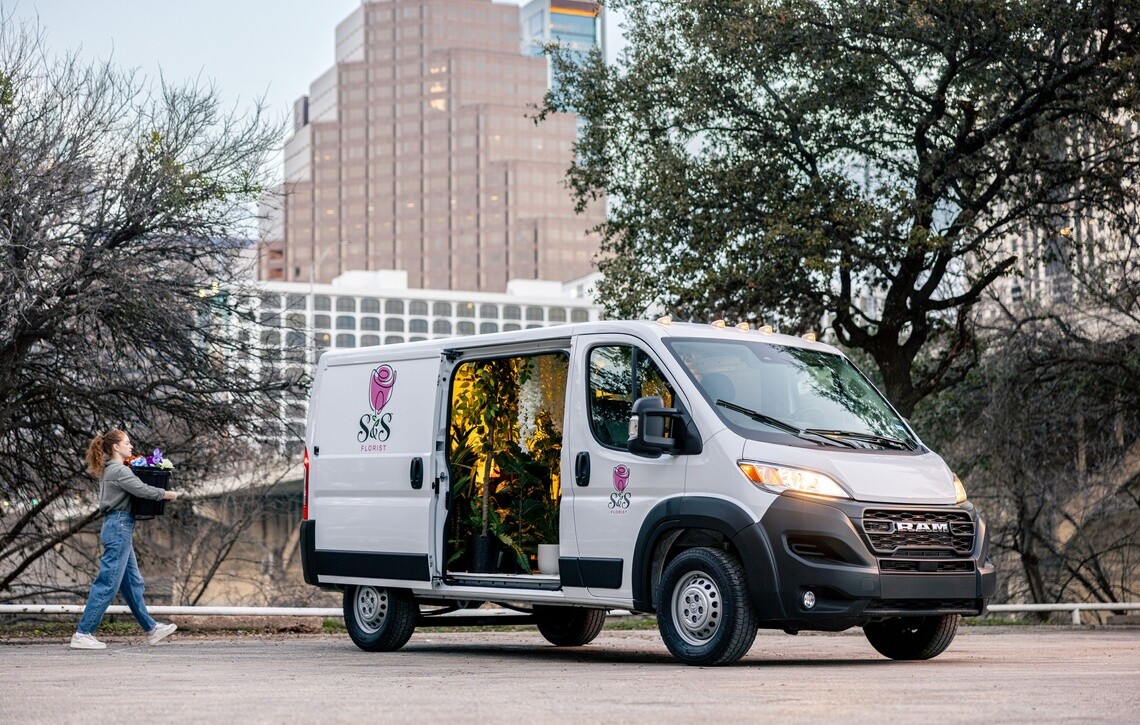 Florist loading up a white commercial van that is equipped with Michelin Agilis tires