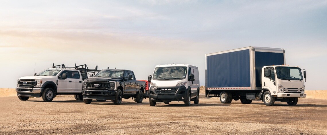Two work trucks, a commercial van and box truck lined up all with Michelin Agilis tires