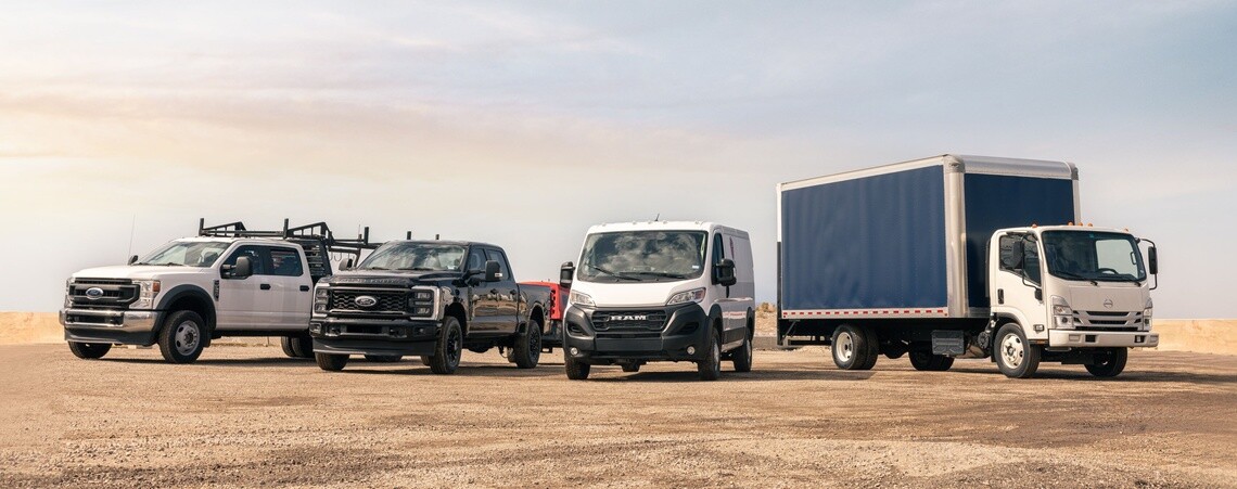 Two work trucks, a commercial van and box truck lined up all with Michelin Agilis tires