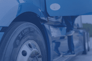 Closeup of the Michelin X Line Z+ tire on the cab of a blue semi truck