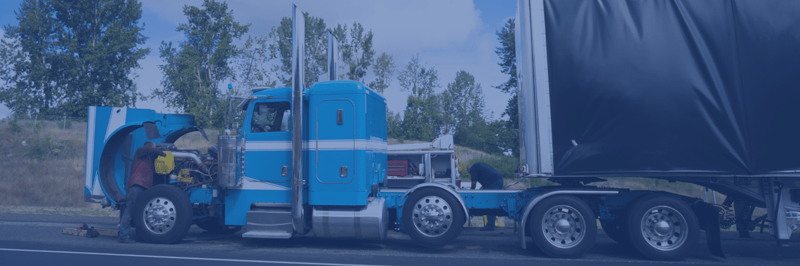 Blue cab semi truck with hood open for repairs